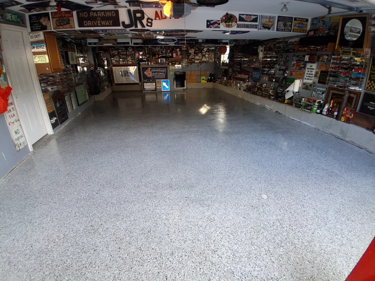 The finished gray flake floor in the Naugatuck garage, glossy under the overhead light
