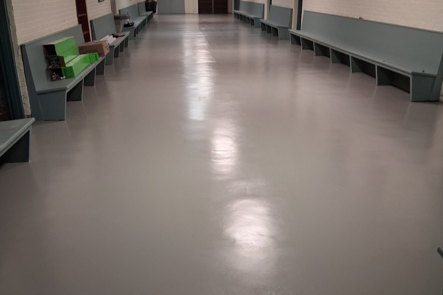 A coated garage floor running back to the door