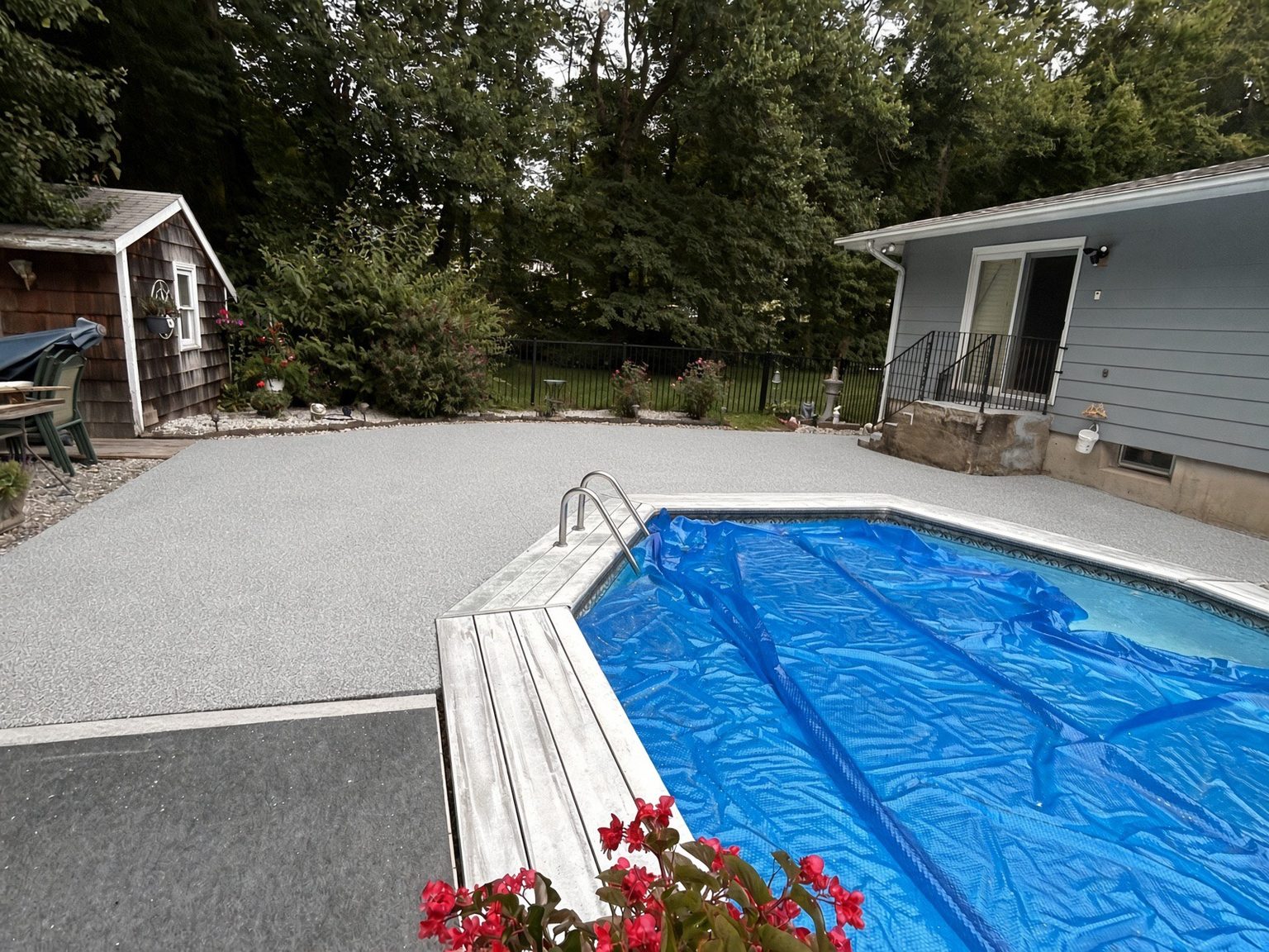 A coated pool surround with a textured finish running to the pool edge